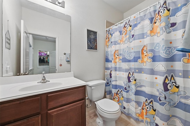bathroom with vanity, toilet, tile patterned floors, and curtained shower