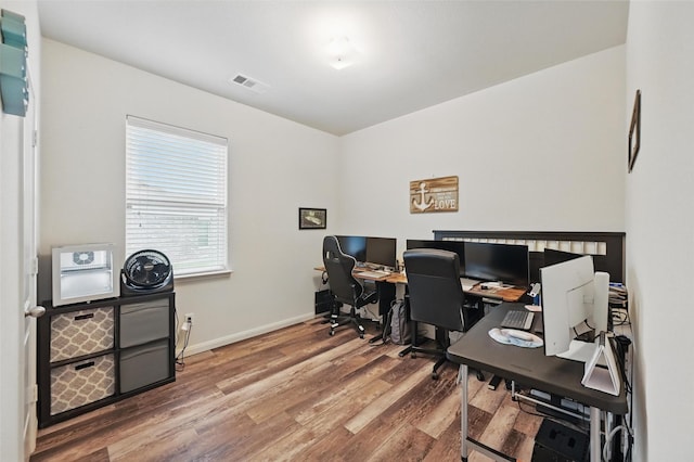 office area with wood finished floors and baseboards
