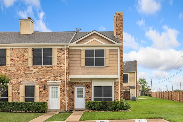 3801 14th St Unit 1607, Plano, TX 75074 - view of front facade with fence, a front yard, a chimney, central AC unit, and a shingled roof