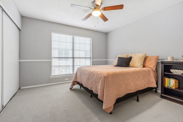 3801 14th St Unit 1607, Plano, TX 75074 - carpeted bedroom with a closet, baseboards, a ceiling fan, and a textured ceiling