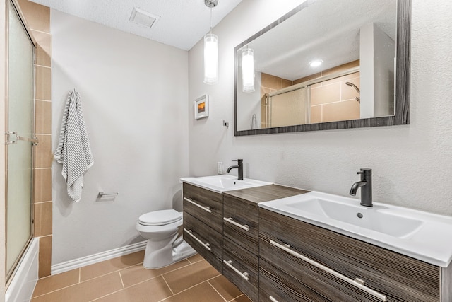 3801 14th St Unit 1607, Plano, TX 75074 - full bath featuring double vanity, toilet, a sink, and tile patterned flooring
