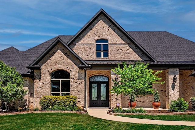210 Tananger Springs Dr, Denison, TX 75021 - french provincial home with french doors, a standing seam roof, a front yard, and brick siding