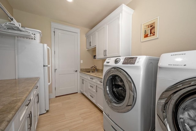 210 Tananger Springs Dr, Denison, TX 75021 - washroom with cabinet space, a sink, washer and clothes dryer, and light wood finished floors