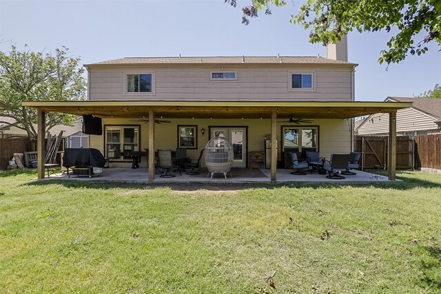 back of house with a ceiling fan, a fenced backyard, a patio area, and a chimney
