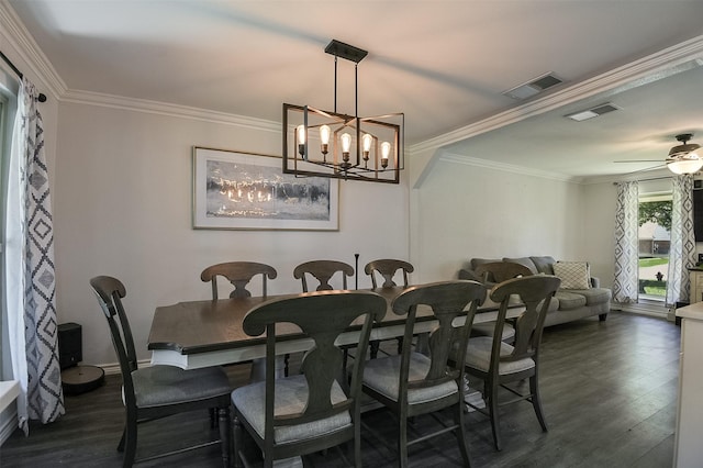 dining space with dark wood-type flooring, ornamental molding, ceiling fan with notable chandelier, and visible vents