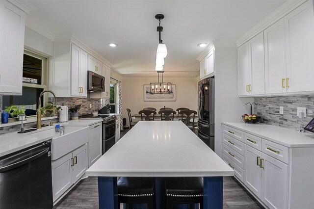 kitchen with an inviting chandelier, freestanding refrigerator, backsplash, and dishwasher