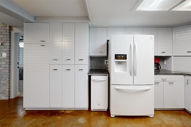 kitchen with white refrigerator with ice dispenser, backsplash, and white cabinetry