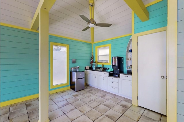 interior space featuring a ceiling fan, exterior kitchen, and a sink