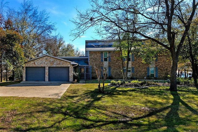 view of front of home with an attached garage, a front lawn, stone siding, and concrete driveway