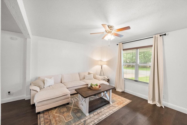 233 NE Moody St, Burleson, TX 76028 - living room with baseboards, ceiling fan, dark wood finished floors, and a textured ceiling