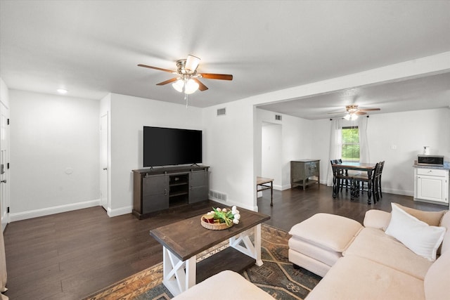 233 NE Moody St, Burleson, TX 76028 - living room with visible vents, dark wood-type flooring, baseboards, and ceiling fan