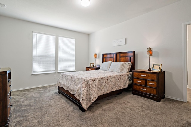 carpeted bedroom featuring baseboards