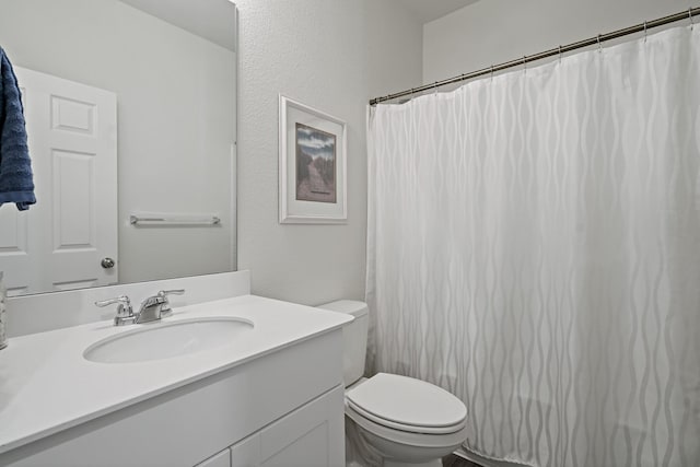 bathroom featuring toilet and vanity