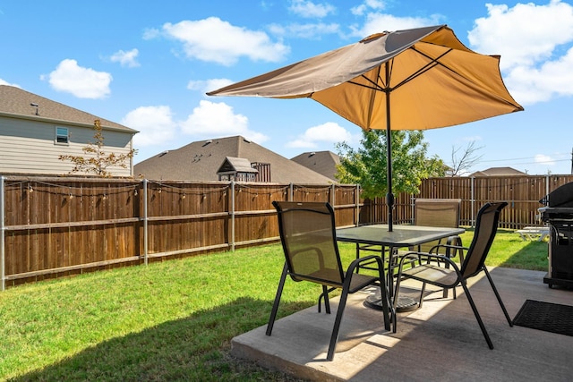 view of yard with a fenced backyard, outdoor dining space, and a patio area