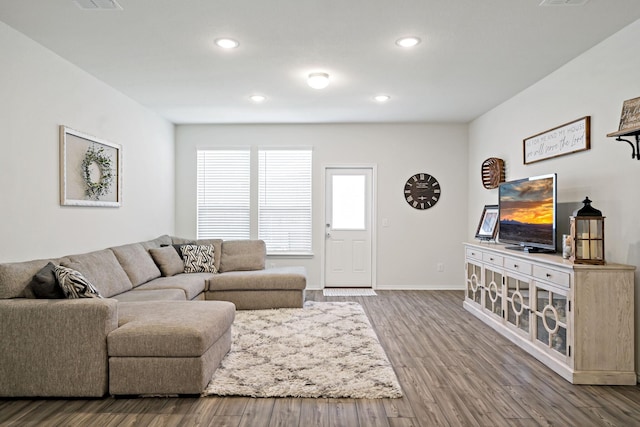 living room with baseboards, recessed lighting, and wood finished floors