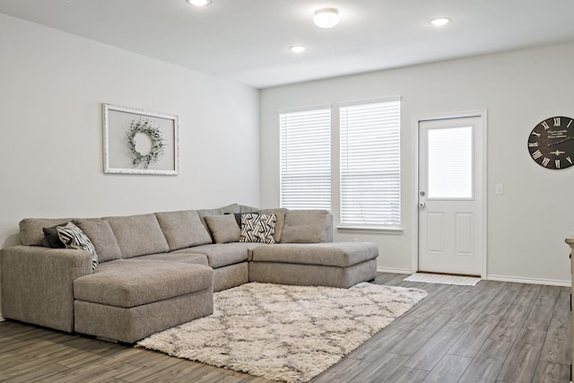 living room featuring baseboards, recessed lighting, and wood finished floors