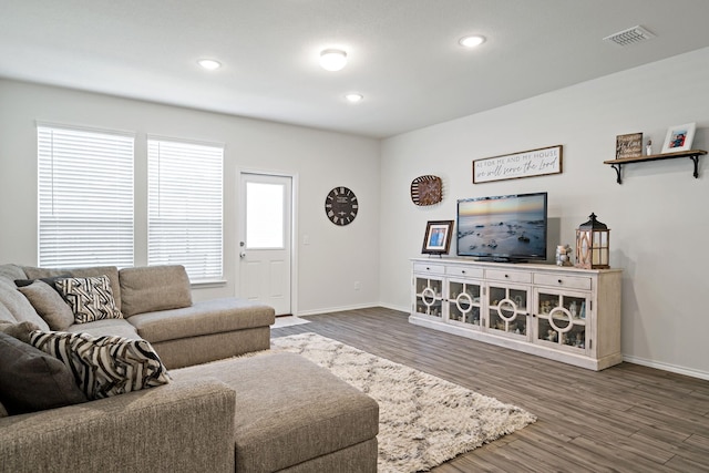 living area with baseboards, recessed lighting, wood finished floors, and visible vents