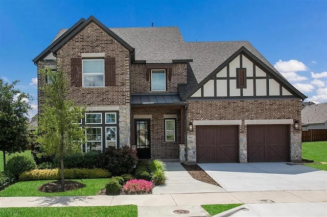 904 Devonshire Dr, Allen, TX 75013 - view of front of home with a standing seam roof, driveway, a front yard, roof with shingles, and brick siding
