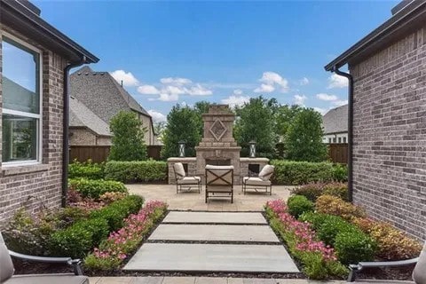 904 Devonshire Dr, Allen, TX 75013 - view of yard with fence, an outdoor fireplace, and a patio area