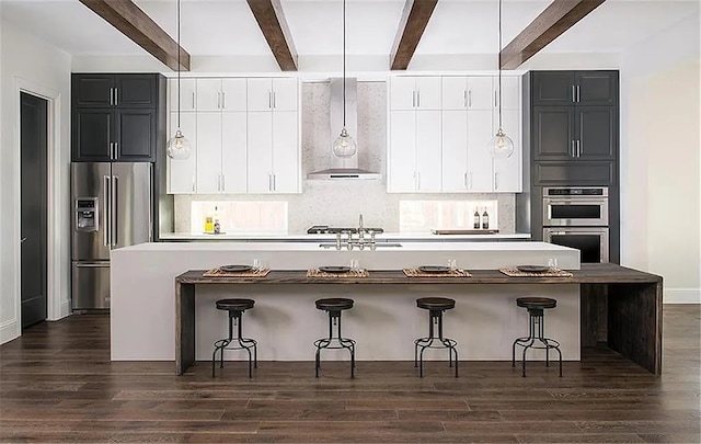 904 Devonshire Dr, Allen, TX 75013 - kitchen with a spacious island, appliances with stainless steel finishes, beam ceiling, and wall chimney range hood
