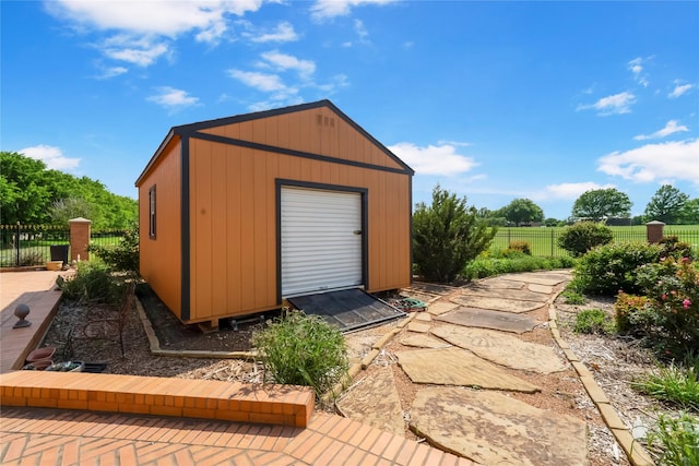 view of outbuilding with fence and an outdoor structure