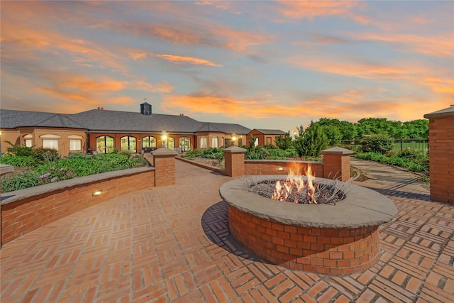 patio terrace at dusk with a fire pit