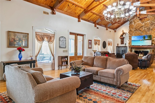living room with wood-type flooring, a notable chandelier, and wood ceiling