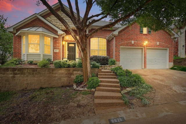8926 White Pine Ln, Dallas, TX 75238 - view of front of house with a garage, driveway, and brick siding