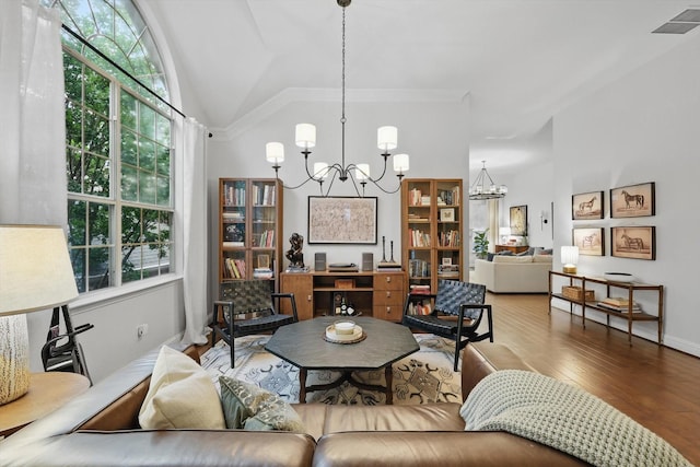 8926 White Pine Ln, Dallas, TX 75238 - living room with visible vents, ornamental molding, lofted ceiling, wood finished floors, and a notable chandelier