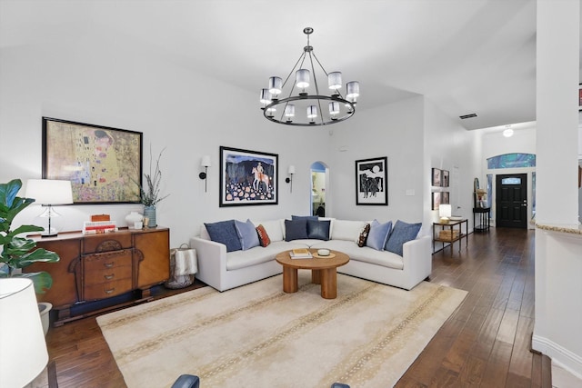 8926 White Pine Ln, Dallas, TX 75238 - living area featuring visible vents, dark wood-style flooring, a towering ceiling, a chandelier, and arched walkways
