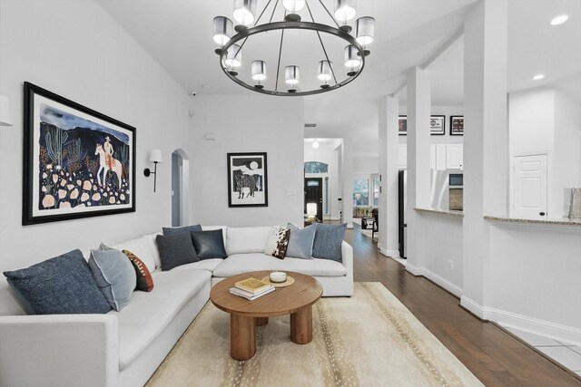 8926 White Pine Ln, Dallas, TX 75238 - living room featuring arched walkways, wood finished floors, baseboards, a notable chandelier, and recessed lighting