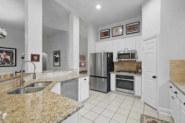 8926 White Pine Ln, Dallas, TX 75238 - kitchen with a sink, appliances with stainless steel finishes, decorative backsplash, and light tile patterned flooring