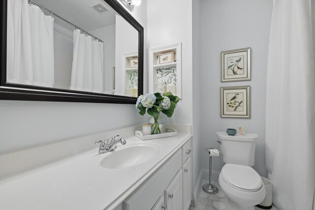 8926 White Pine Ln, Dallas, TX 75238 - full bath featuring visible vents, vanity, baseboards, toilet, and marble finish floor