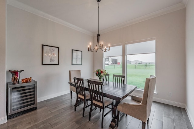 dining space featuring an inviting chandelier, ornamental molding, dark wood-style flooring, and wine cooler