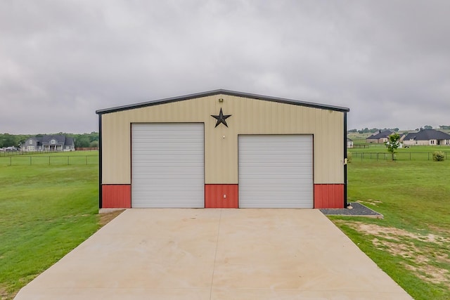 detached garage featuring fence