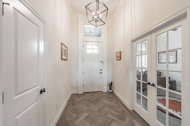 interior space with baseboards, an inviting chandelier, a wealth of natural light, and french doors