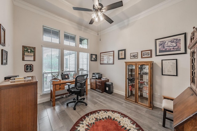 office with crown molding, baseboards, a ceiling fan, and wood finished floors