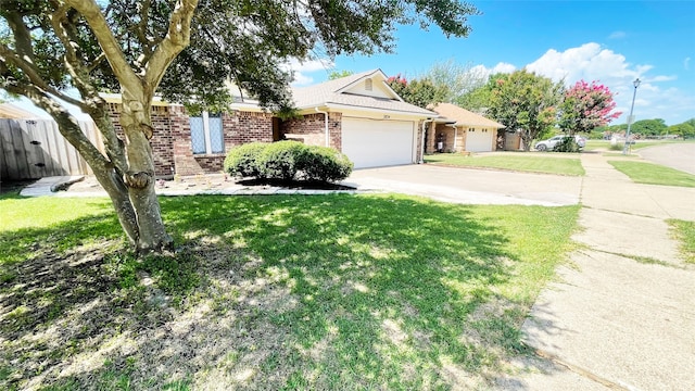 ranch-style home featuring fence, a front lawn, brick siding, a garage, and driveway