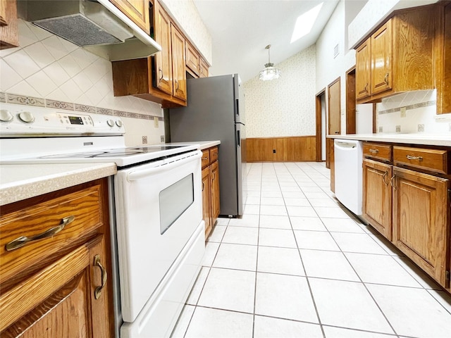 kitchen featuring brown cabinets, wallpapered walls, under cabinet range hood, and white appliances