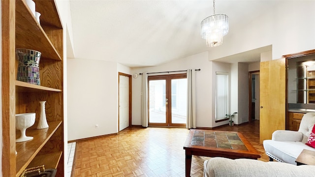 living room featuring baseboards and a notable chandelier
