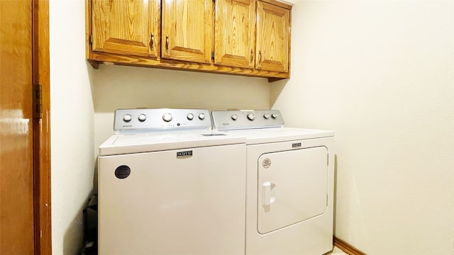 laundry area featuring cabinet space and washing machine and clothes dryer