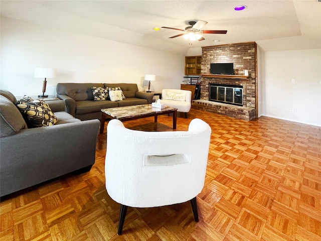 living room featuring a ceiling fan and a brick fireplace