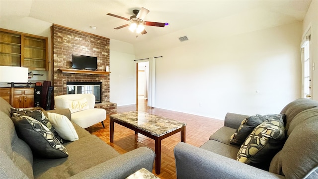 living area with visible vents, a brick fireplace, baseboards, and ceiling fan