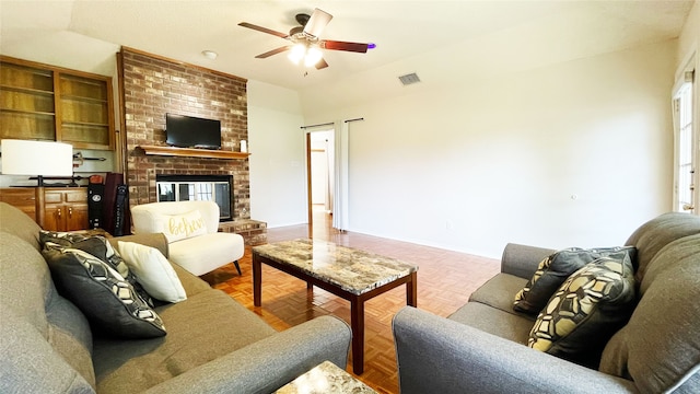living area with a fireplace, a ceiling fan, baseboards, vaulted ceiling, and visible vents