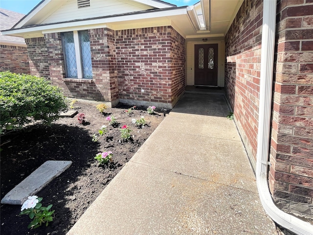 property entrance featuring brick siding