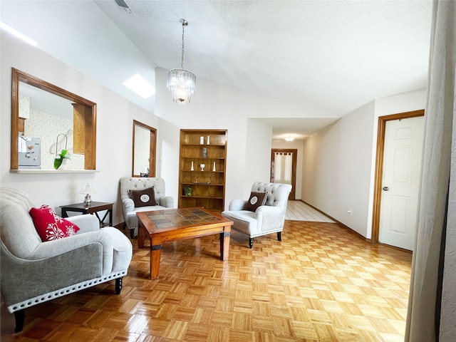 sitting room featuring baseboards, a notable chandelier, and vaulted ceiling