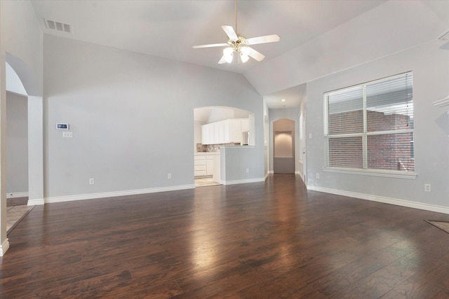unfurnished living room featuring visible vents, lofted ceiling, ceiling fan, dark wood-style floors, and arched walkways
