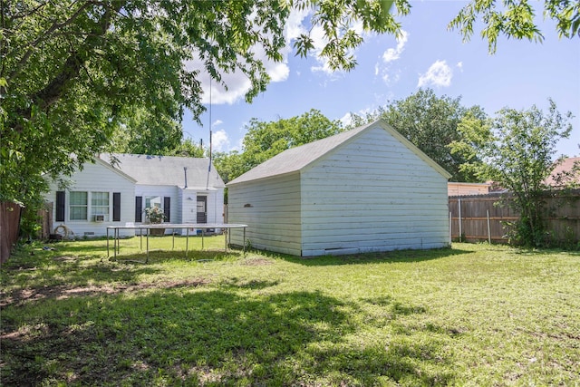 2612 1st St, Brownwood, TX 76801 - back of property with a trampoline and an outbuilding