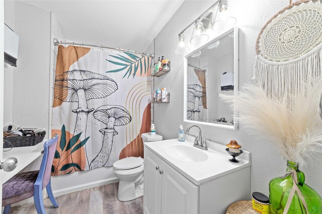 2612 1st St, Brownwood, TX 76801 - bathroom featuring wood finished floors, vanity, and toilet