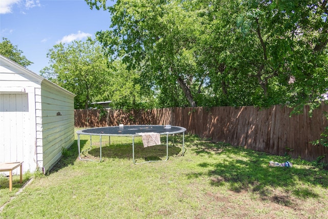 2612 1st St, Brownwood, TX 76801 - view of yard featuring a trampoline and an outbuilding